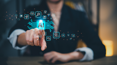 A person in a suit pointing at a glowing 'AI' icon on a virtual interface, surrounded by smaller icons representing technologies like search, cloud storage, and data analysis, with a blurred background emphasizing the hand and digital elements.